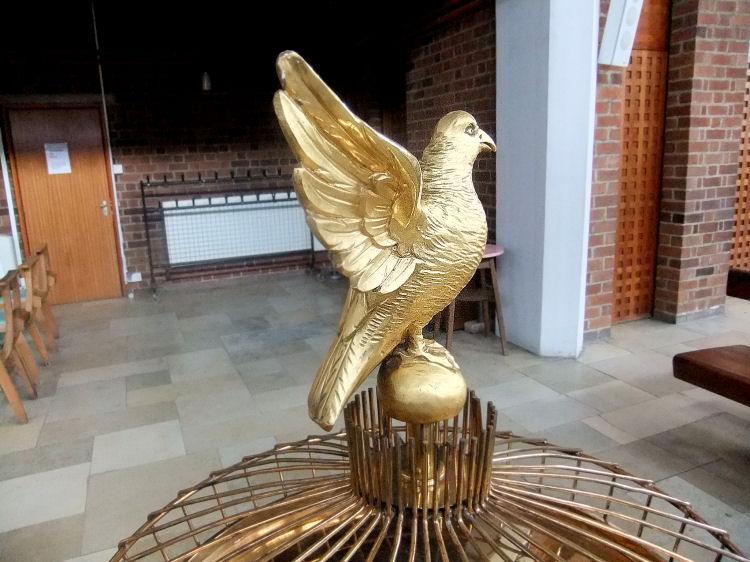 Golden dove over the baptismal font at  St Charles Borromeo Church, Glasgow