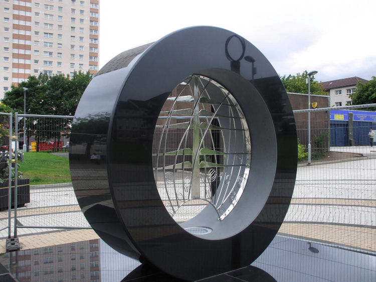 Mackintosh inspired tree and rose symbols at centre of polished stone ring