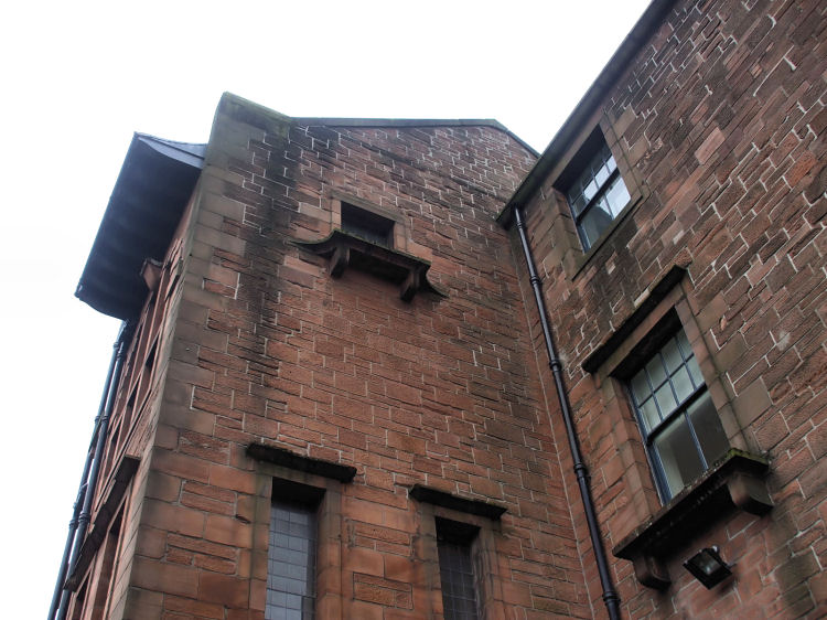Looking up at stonework over main entrance to Martyrs School
