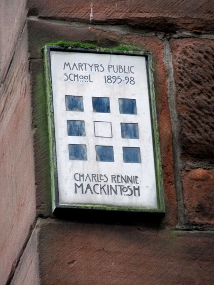 Commerative plaque attached to wall of Martyrs School