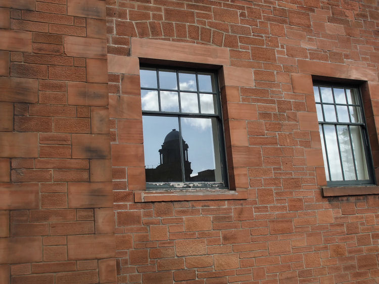 Reflection of Royal Infirmary in window at south fa�ade of Martyrs School