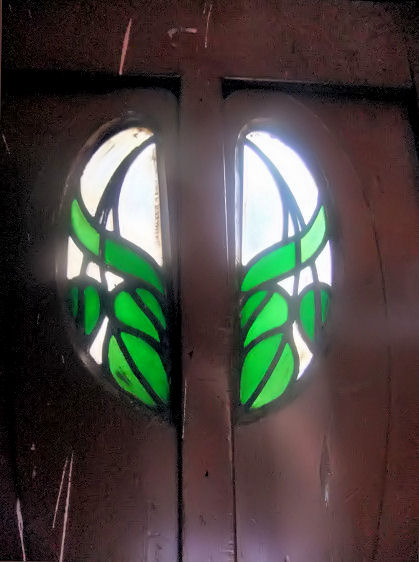 Green leaf motifs in glass at Ruchill Church Hall