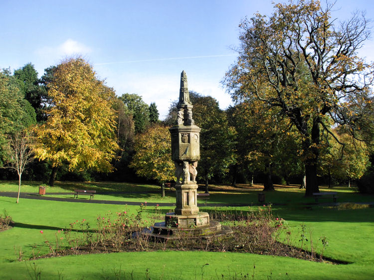 Ornamental sundial beside walled garden
