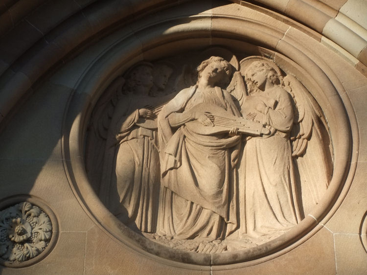 Sculptural detail at Camphill Church of angel with lyre