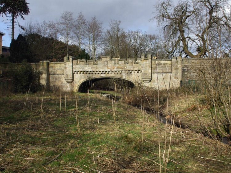 Stone castellated bridge over Castlemilk Burn dating from 1833, refurbished in 2001/2002