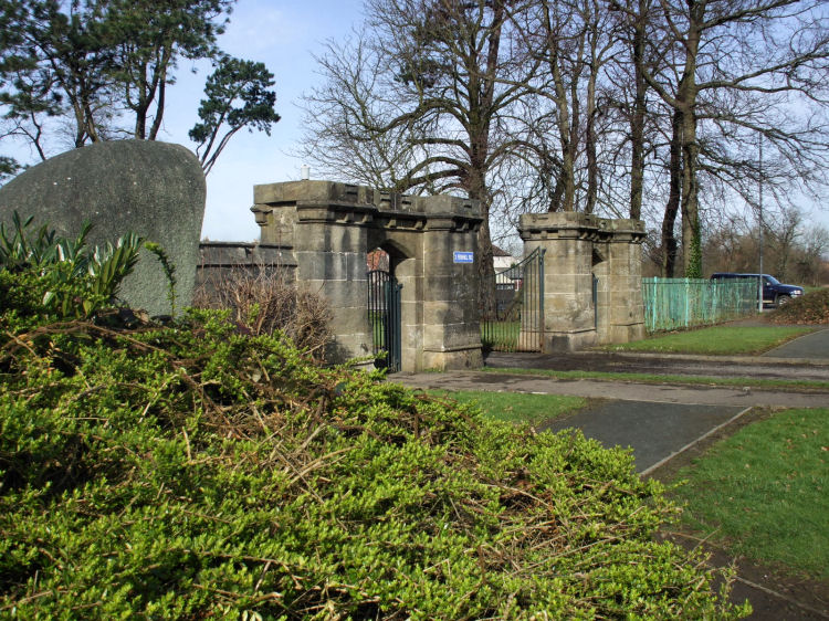 Stone castellated gate piers at eastern entrance to estate