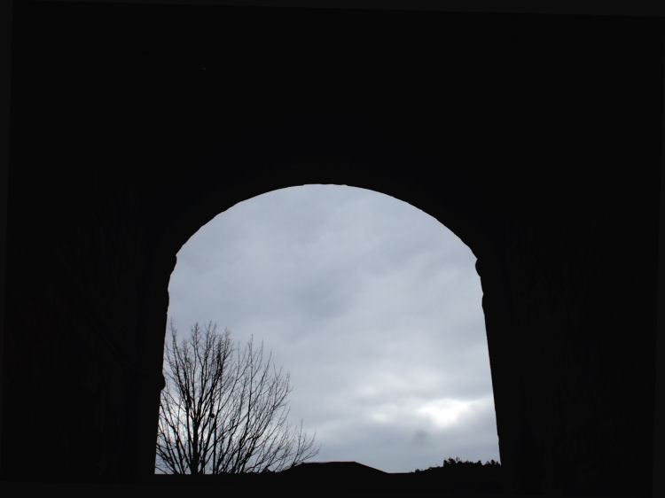 Deep shadows under the arch at stables