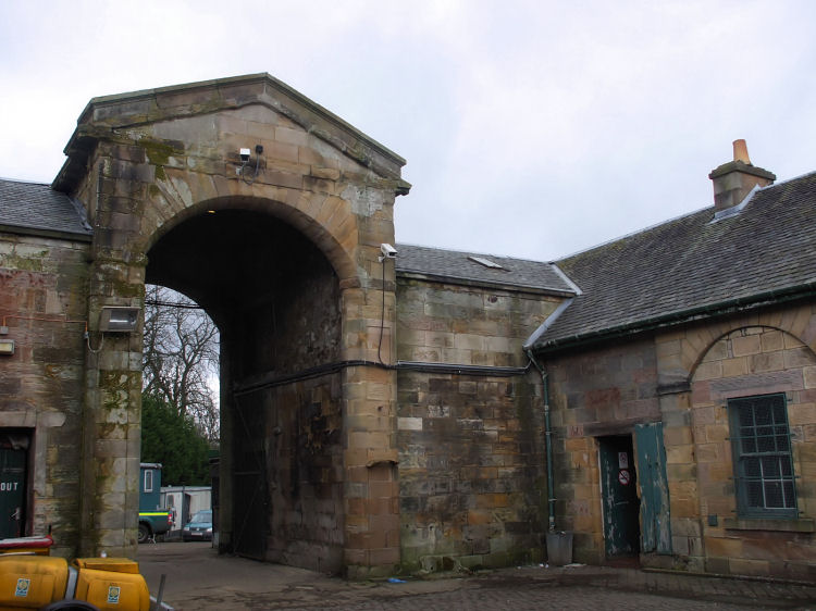 Huge arched entrance to park from cobbled stables courtyard