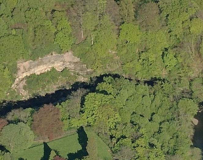 Exposed layers of rock on riverbank facing Millholm Paper Mill