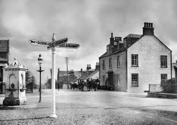 Signpost and drinking fountain opposite Newton Inn at Mearns Cross