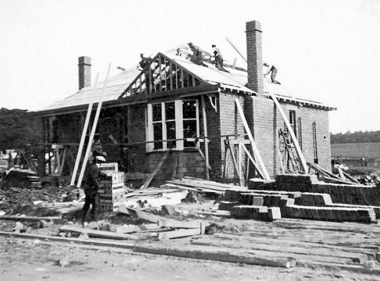 Construction of detached bungalow in Menock Road, King's Park, showing concrete blocks and roof tiles, c.1930