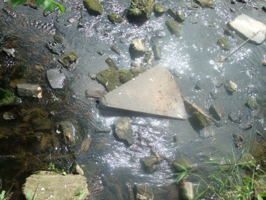 Old grindstone on river bed near site of Millholm Paper Mill