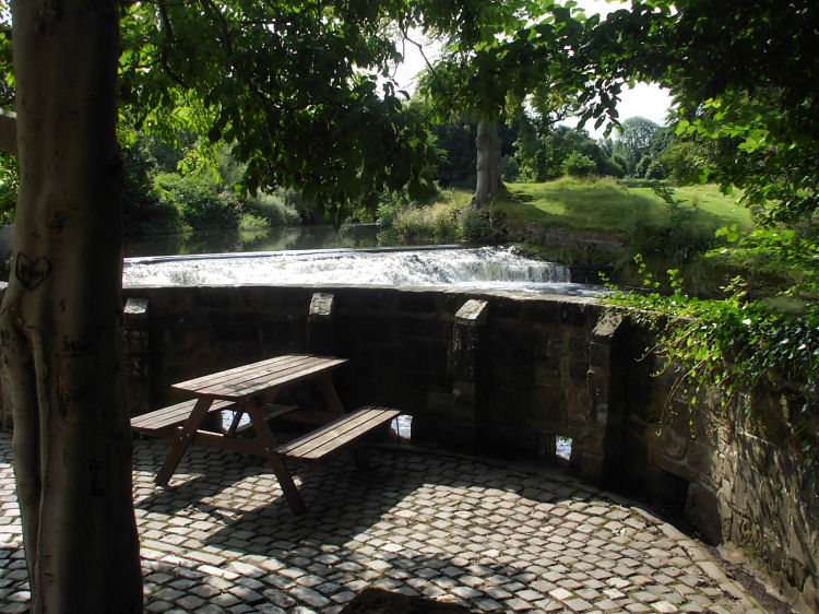 Picnic table at weir on White Cart Water