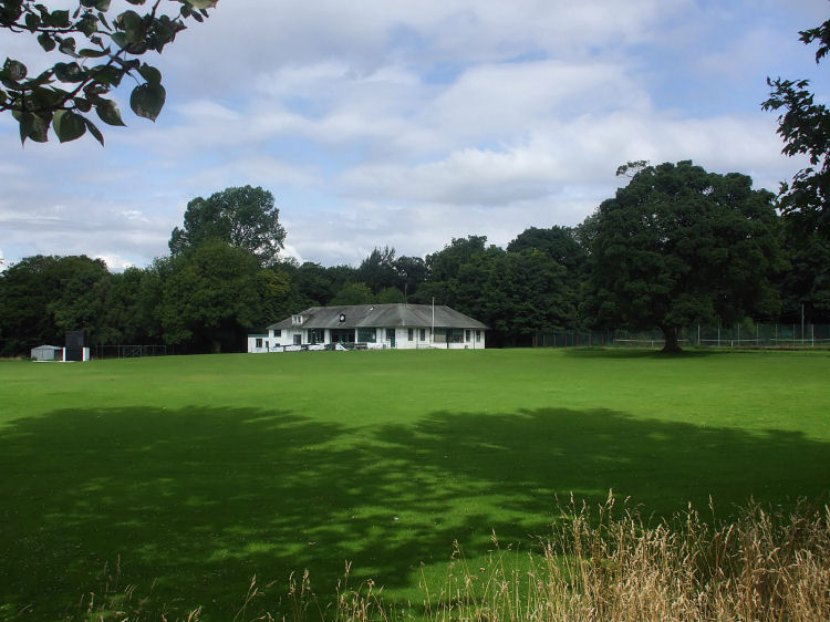 View of clubhouse and grounds of Poloc Cricket Club from riverside path