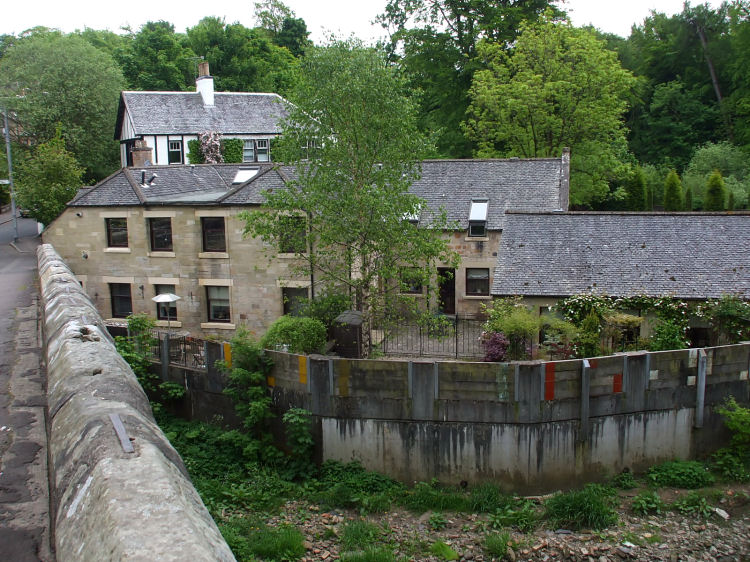 Rebuilt housing at site of Snuff Mill with modern defences from the river, which was at a very low level after a dry spell