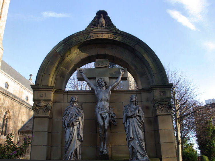 Crucifixion scene at St Mary's war memorial; columns are headed with aplha and omega symbols