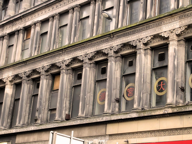 Decorated pilasters and stonework above shops at Egyptian Halls, Glasgow 