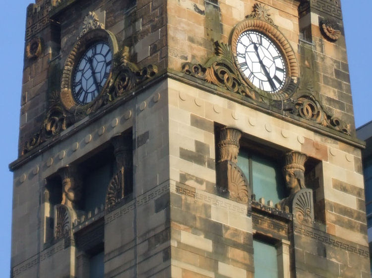 Ornamental carvings around clock at St Vincent Street Church