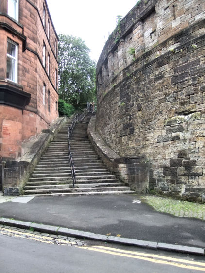 View from the bridge of retaining wall, stairway and later red sandstone tenement