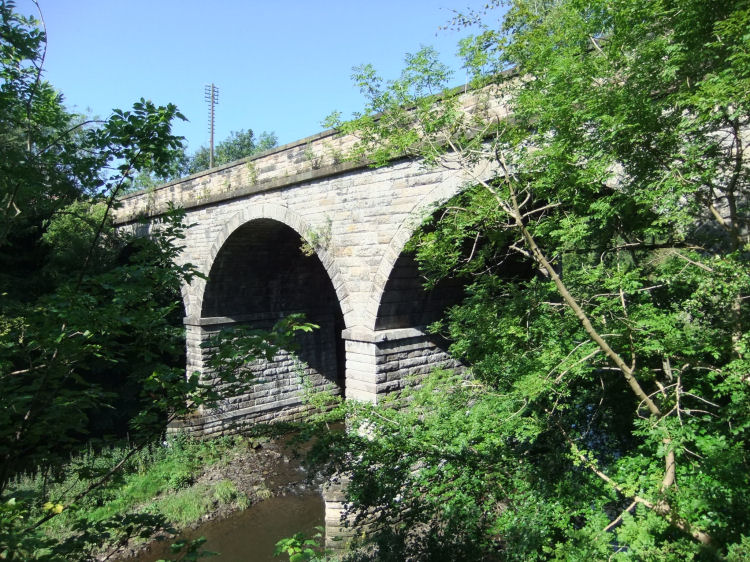Abandoned railway bridge over River Kelvin carrying line towards Botanic Gardens