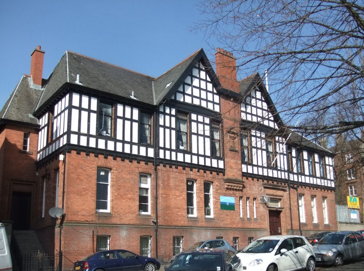 Red brick Drill Hall in Jardine Street with timber Tudor style upper floor