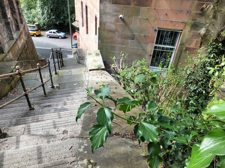 Looking down the edge of the stairway tagged on to the wall