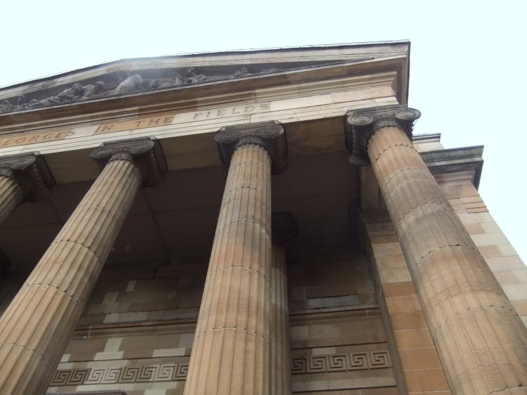 Looking upwards at the portico of St George's in the Fields Church